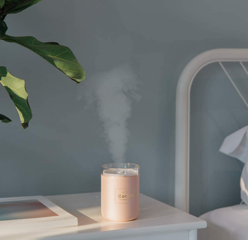 Candle humidifier in pink, green, and black